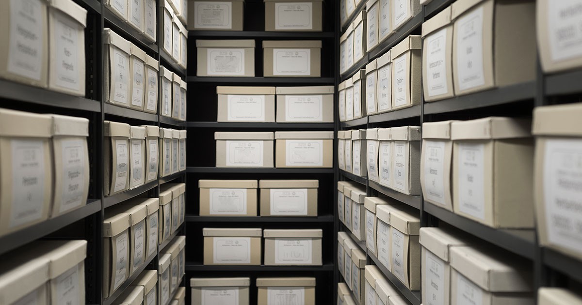 Indoor storage details in a manufacturing enterprise, black shelves with white office boxes